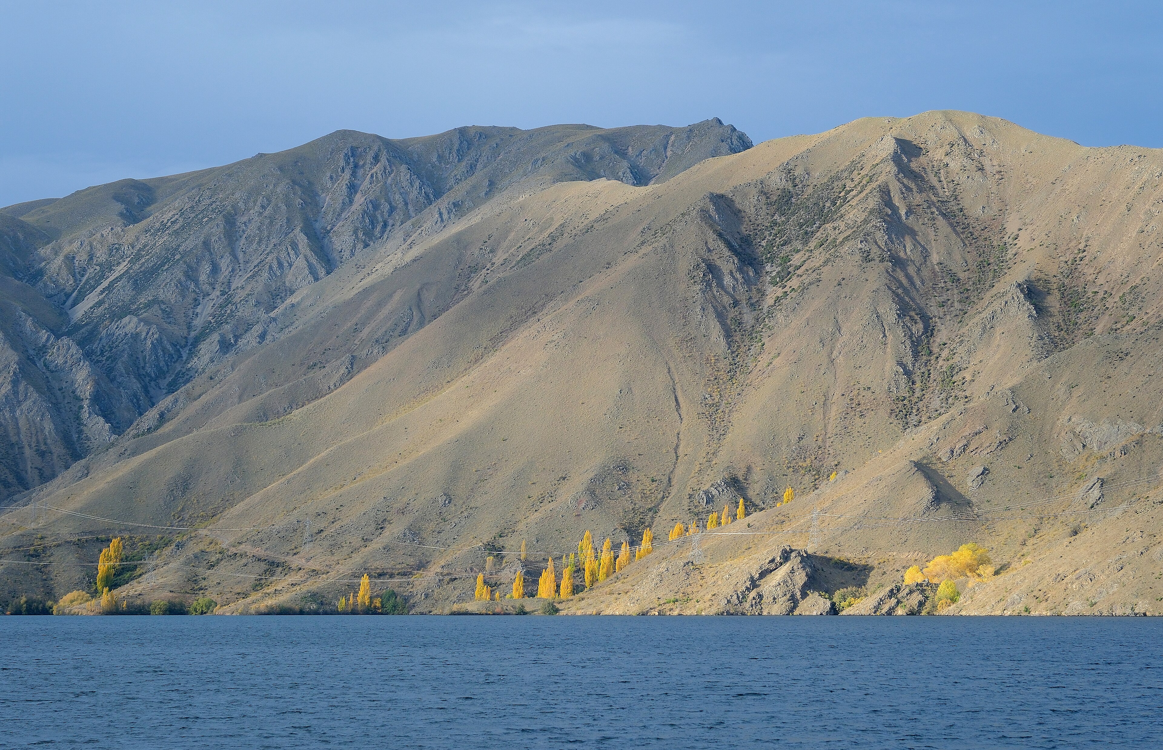 High voltage transmission lines crossing mountains near Lake Benmore, New Zealand