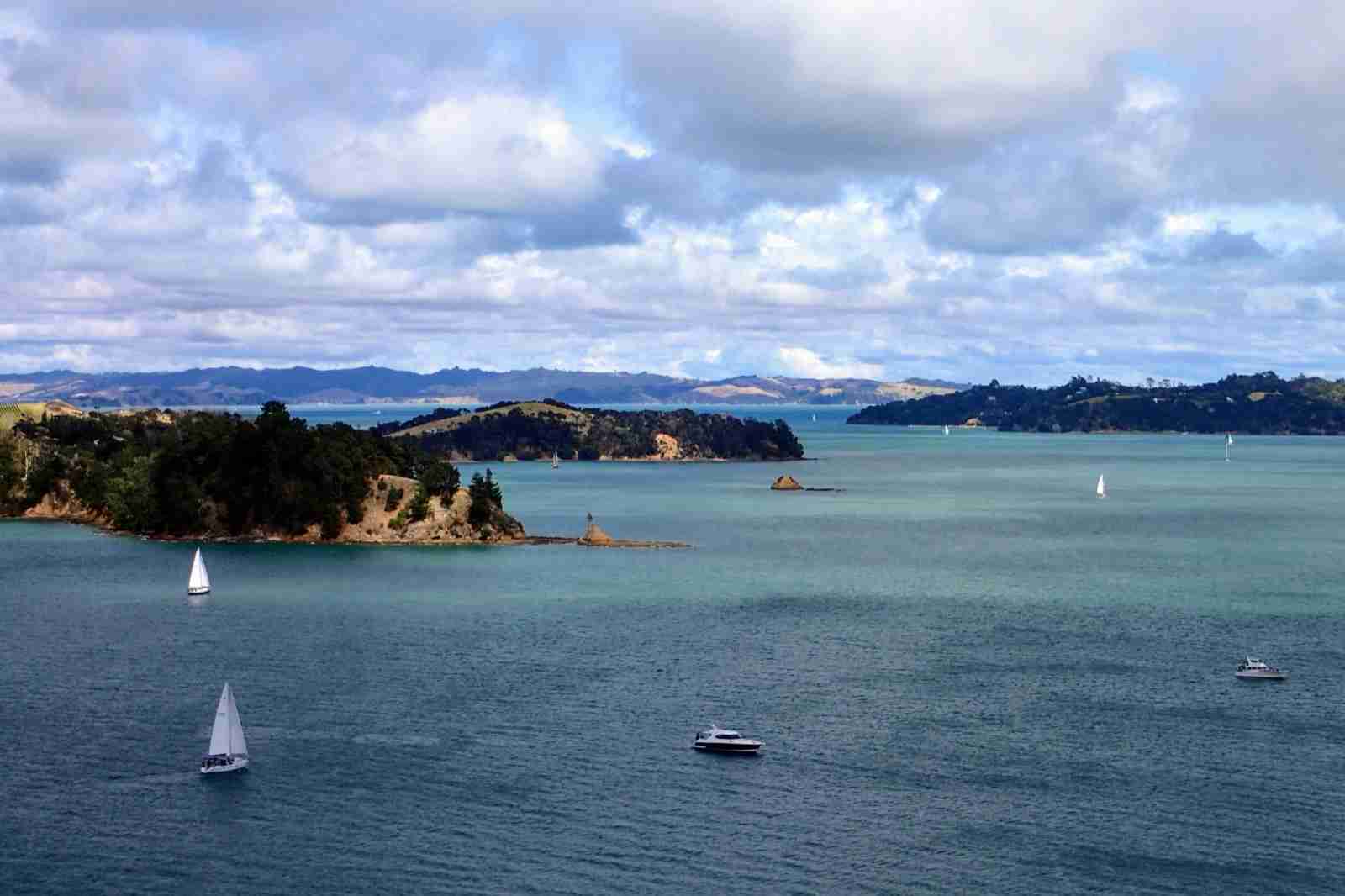 Sailing yachts on the Hauraki Gulf seen from Rotoroa Island, with Ponui Island and Waiheke in the distance.