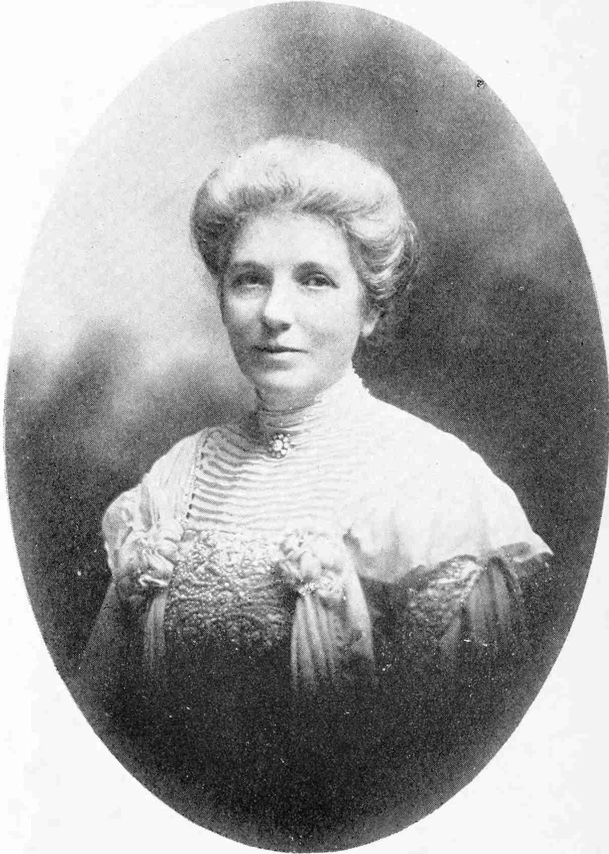 A formal black-and-white portrait of Kate Sheppard in her early fifties, seated, looking past the camera.
