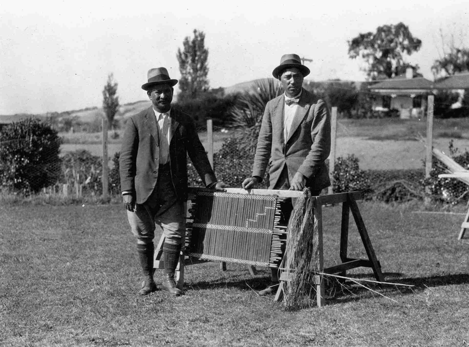 Āpirana Ngata and Peter Buck inspecting a tukutuku panel together at Waiomatatini in 1923 during a Dominion Museum ethnological expedition