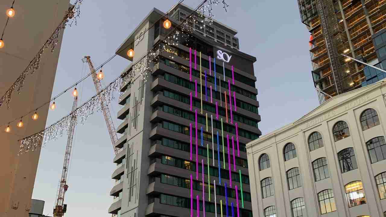 SO/ Auckland design hotel lit up at dusk on Customs Street