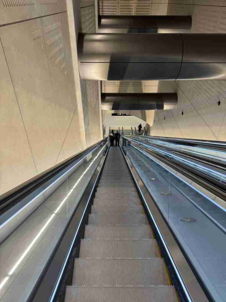 Long escalators descending to the platforms at Karanga-a-Hape Station on the City Rail Link