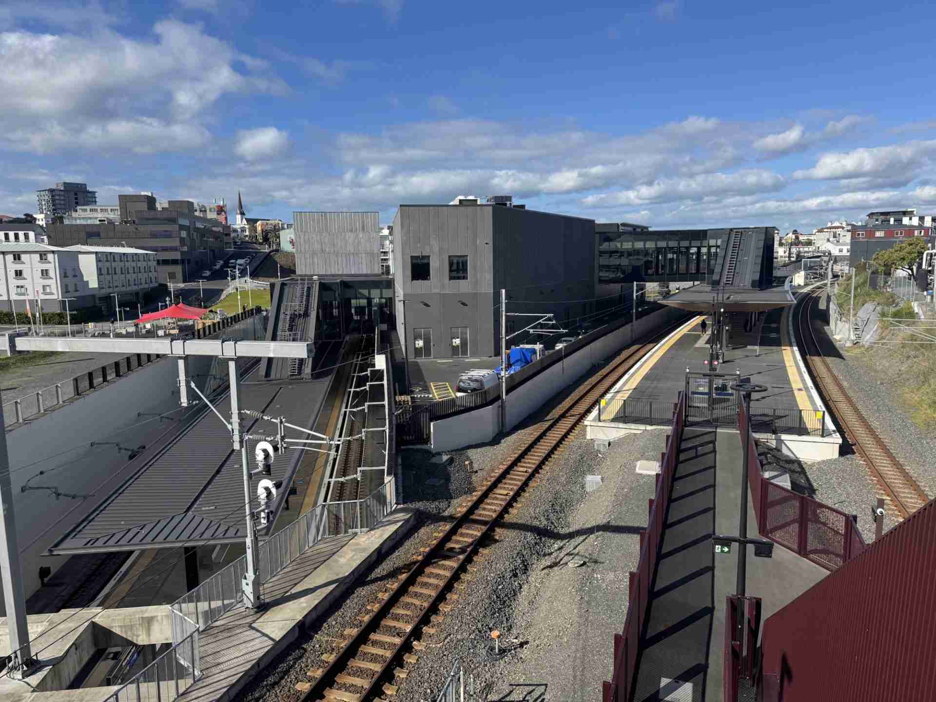 Maungawhau Station seen from above, with the platform canopy, station building and tracks in the open-air cutting